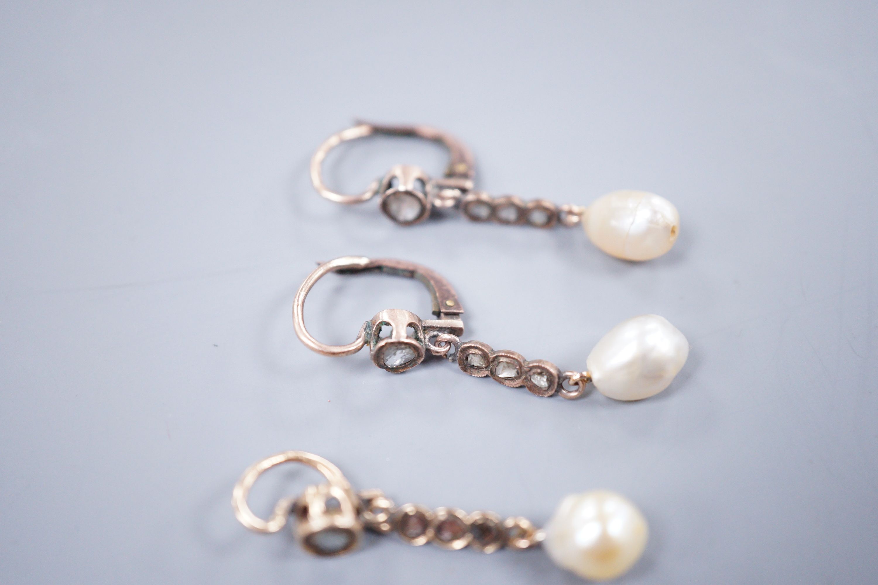 A pair of yellow metal, baroque pearl and rose cut diamond set drop earrings, 38mm and a similar pendant, gross weight 5.9 grams.